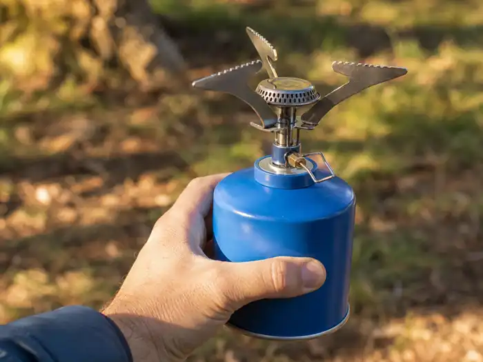Portable camping gas canister with stove burner for outdoor cooking